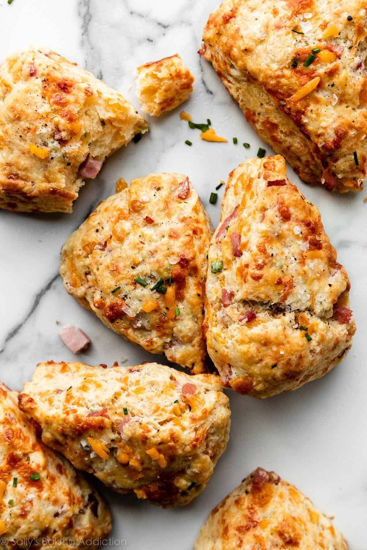 ham and cheddar cheese scones with chives and sea salt on marble counter