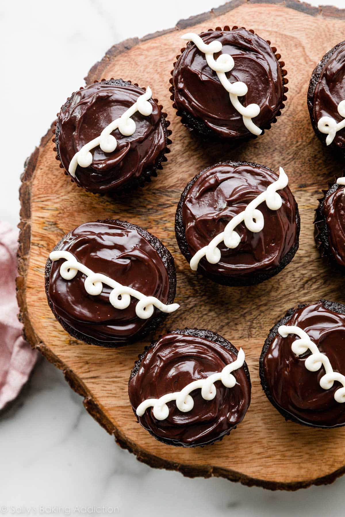 homemade version of Hostess cream-filled chocolate cupcakes on wooden cake stand.