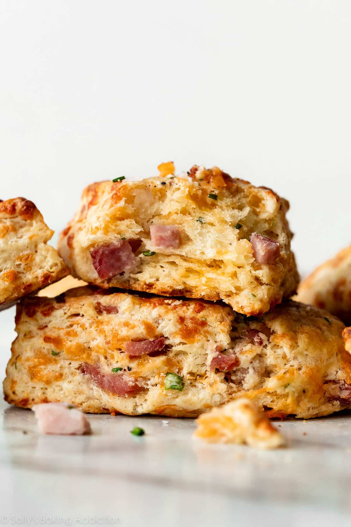 cheddar cheese ham scone torn in half to reveal flaky center.