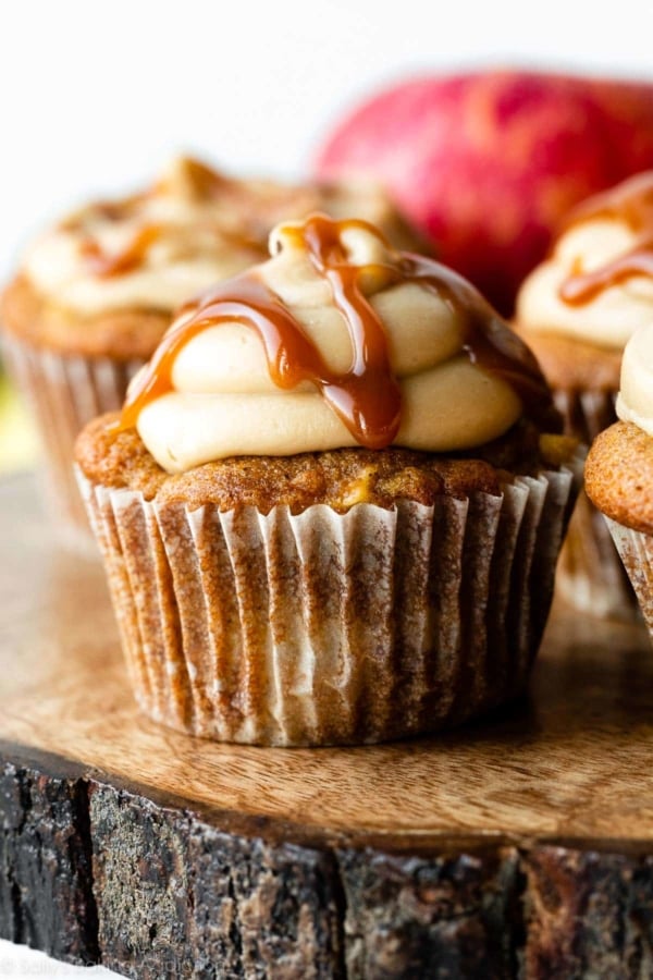 apple cupcake with caramel frosting and salted caramel drizzled on top.