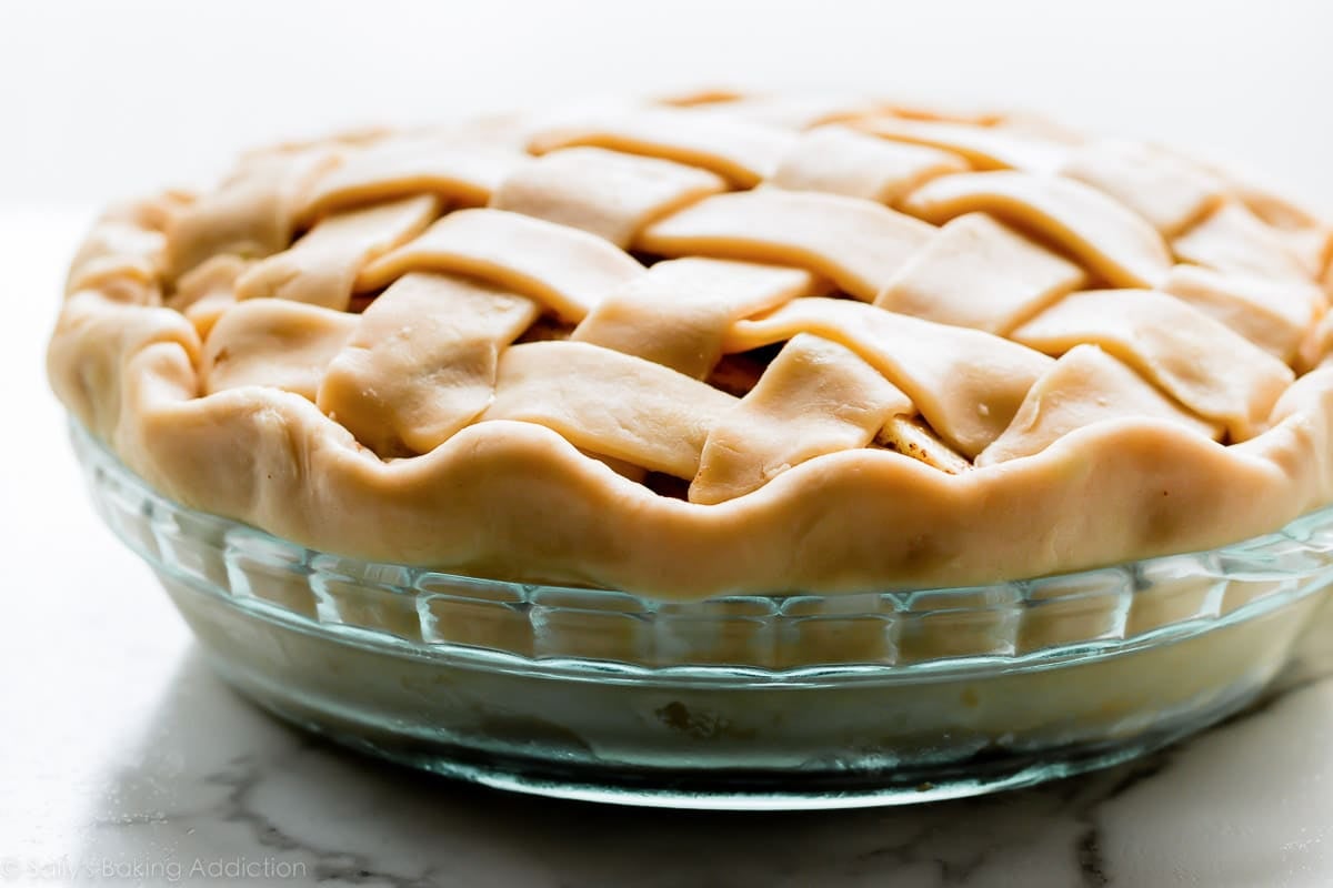 straight-on photo of unbaked pie in a glass pie dish.