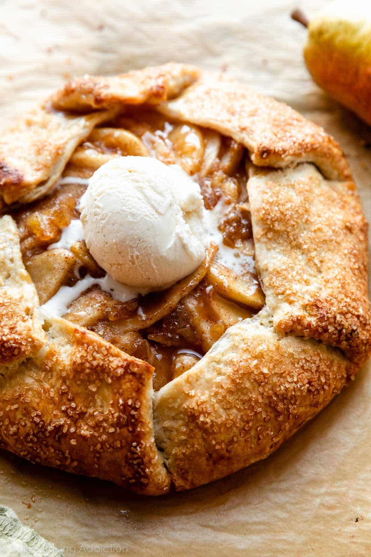 whole pear galette with vanilla ice cream on top.
