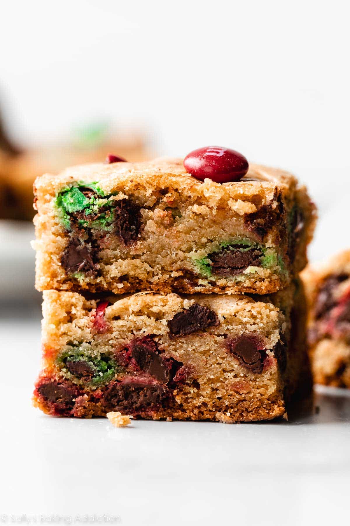 stack of 2 M&M cookie bars with red and green Christmas color M&Ms.