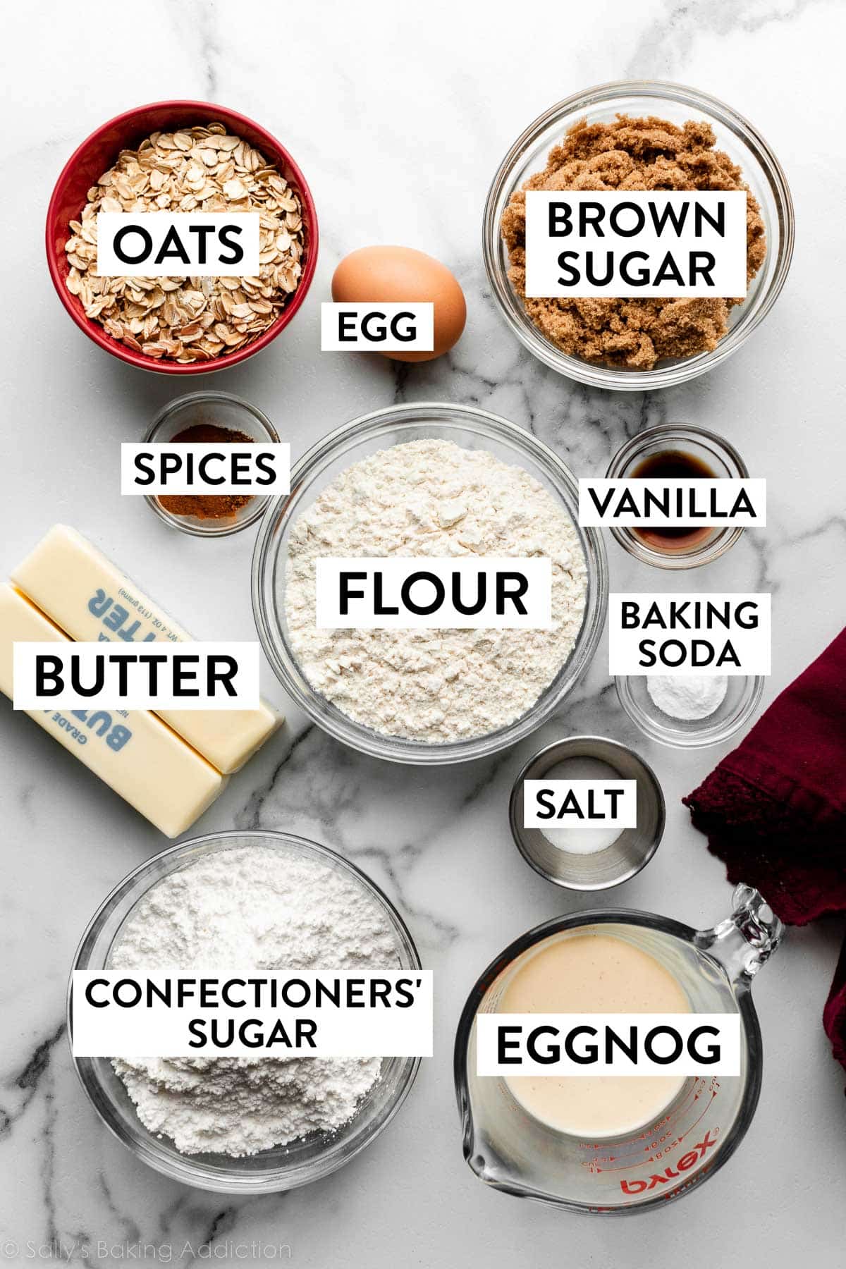 bowls of ingredients including brown sugar, oats, vanilla, flour, confectioners' sugar, salt, eggnog, and more.