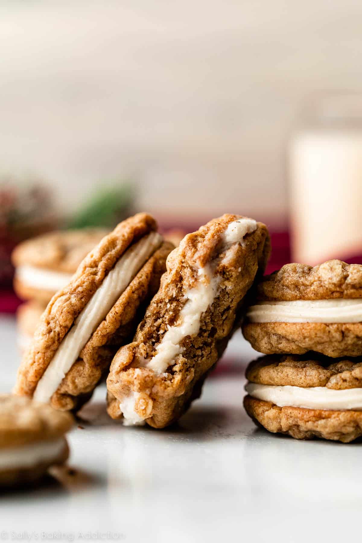eggnog oatmeal cream pies with one bite taken out of one of the cookie sandwiches.