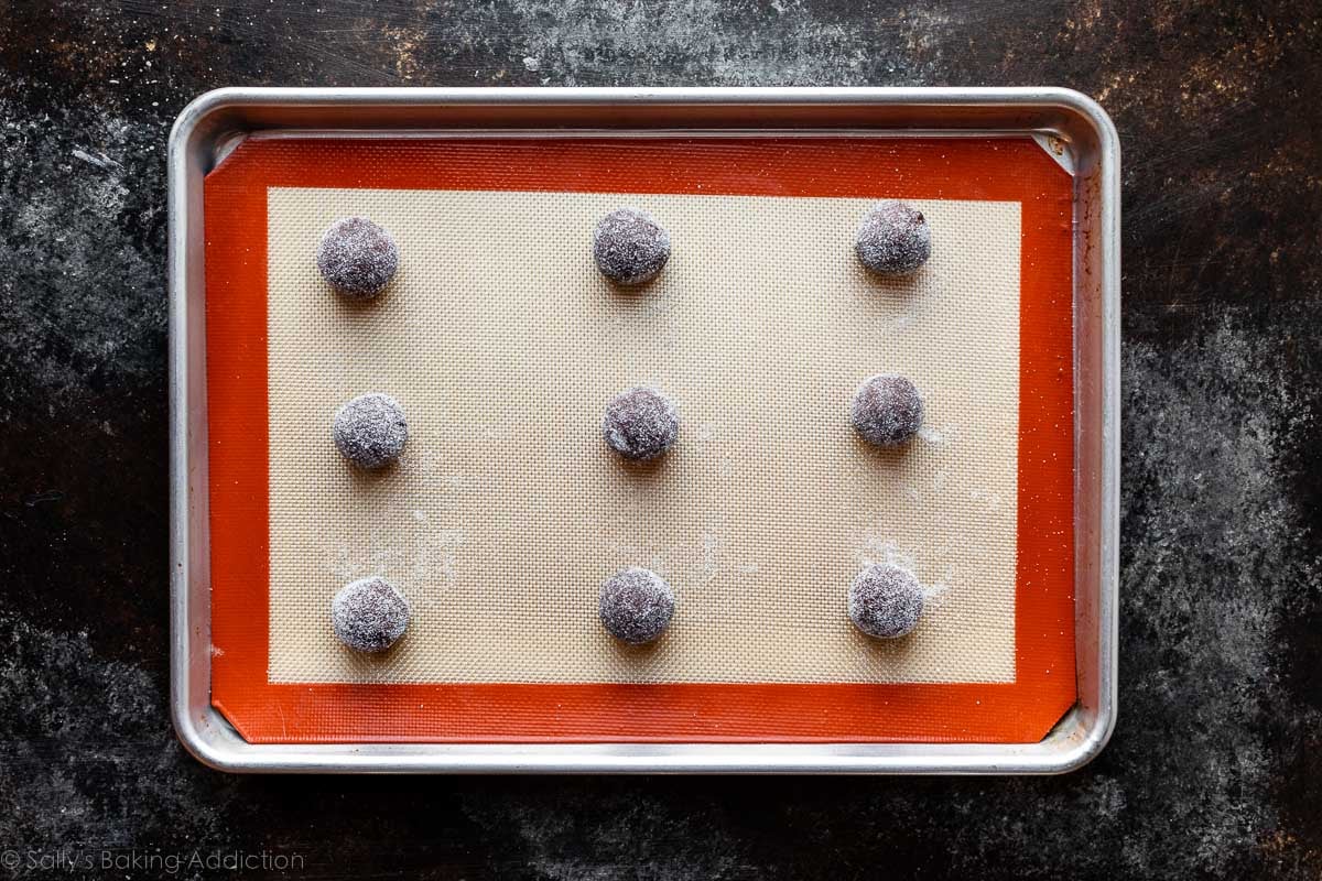 chocolate cookie dough balls on Silpat-lined baking sheet.