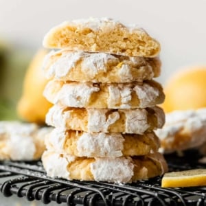 stack of lemon crinkle cookies coated in confectioners' sugar.