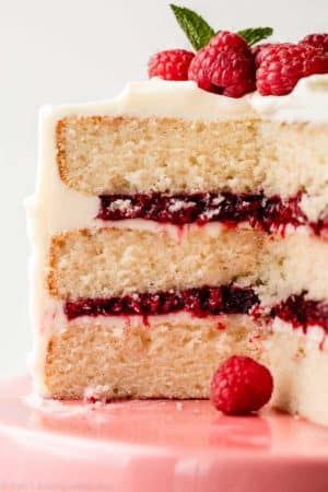3 layer white vanilla cake cut open to reveal raspberry cake filling inside.
