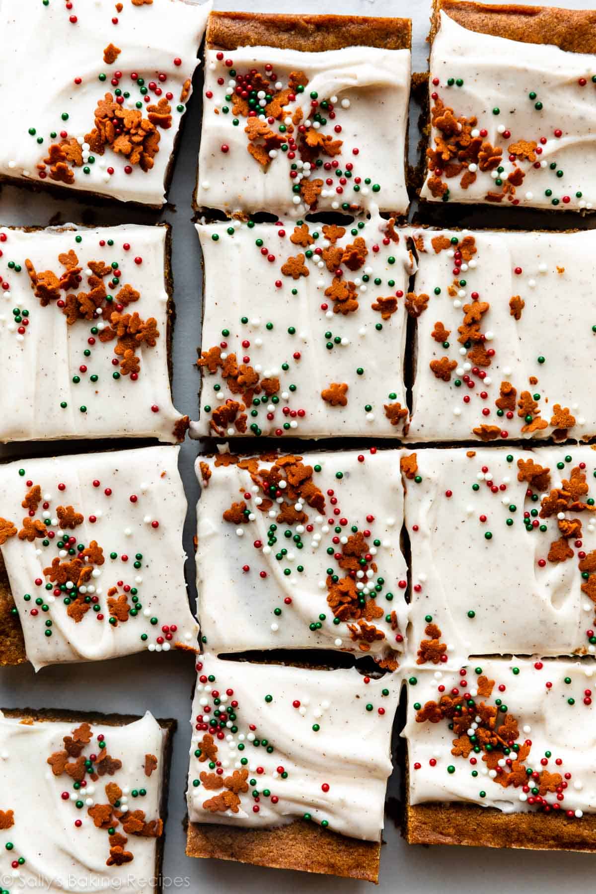 overhead photo of frosted gingerbread cookie bars with Christmas nonpareils and gingerbread cookie sprinkles on top.