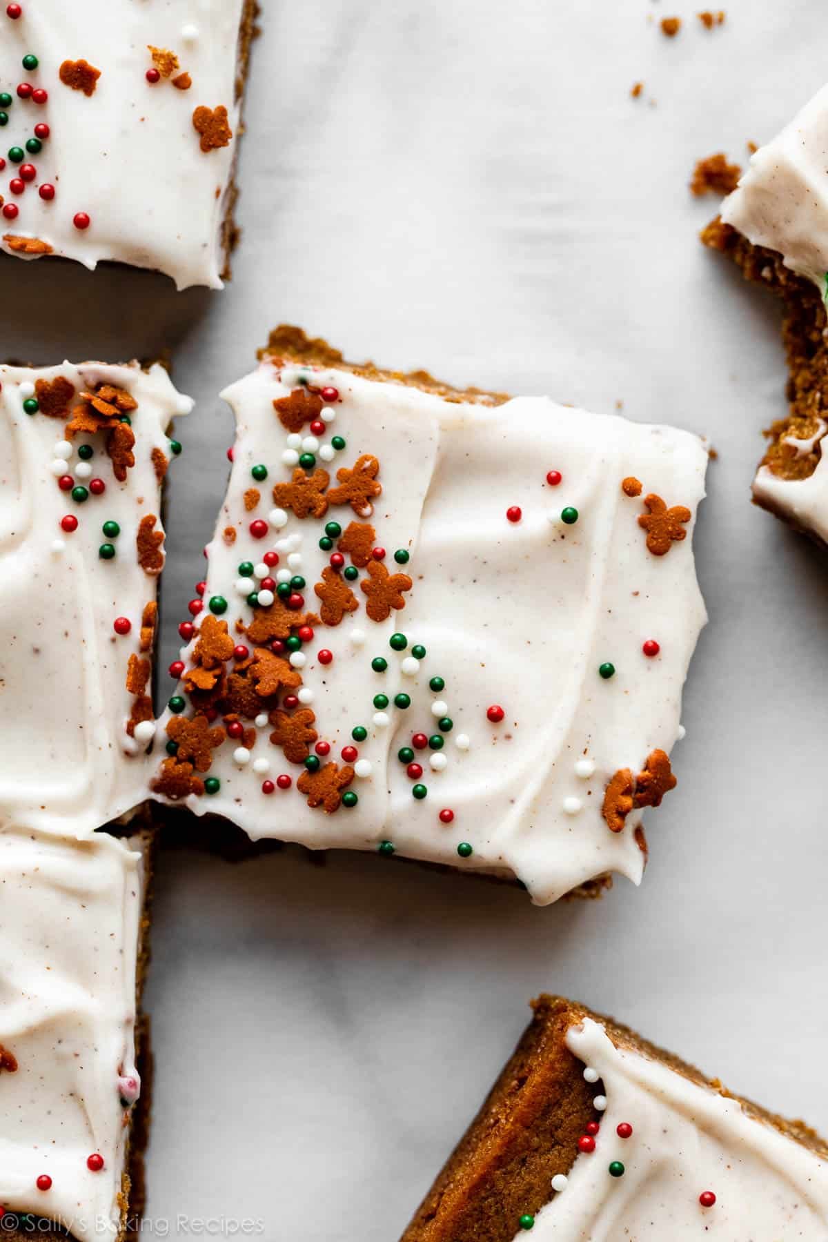 frosted gingerbread cookie bars with gingerbread cookie sprinkles on top.
