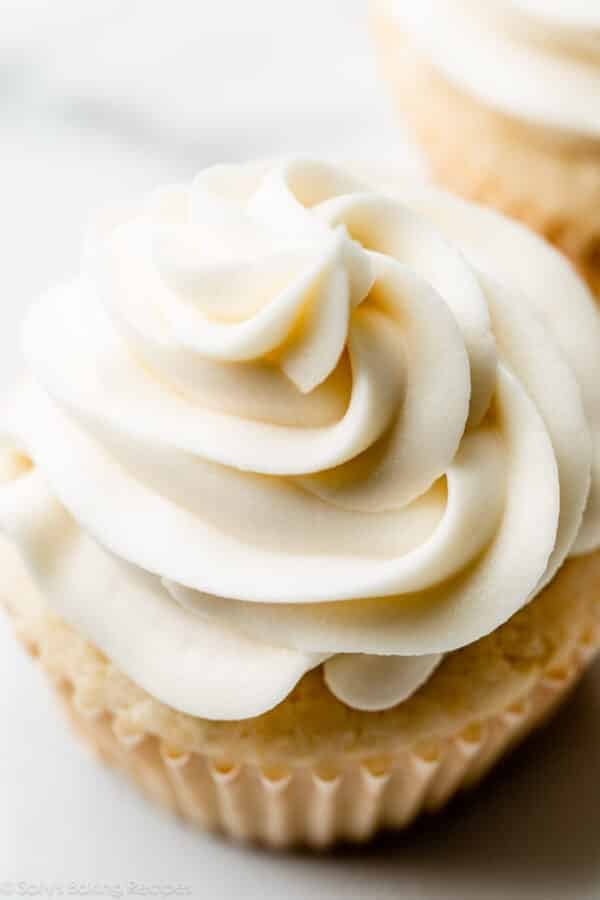 close-up image of white chocolate buttercream swirled on a cupcake.