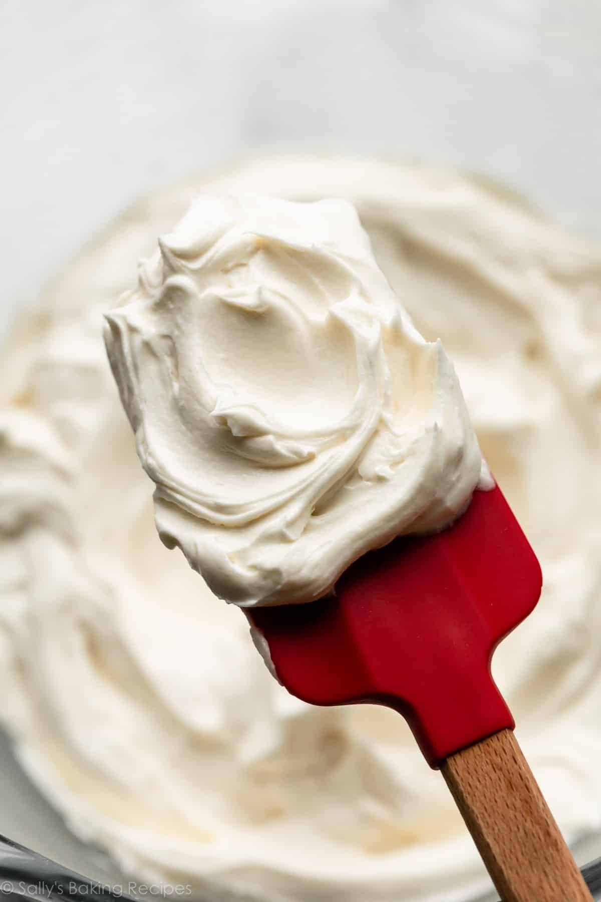 white chocolate frosting buttercream on red spatula.