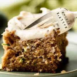 slice of zucchini cake with fork about to remove a bite.