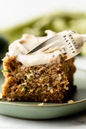 slice of zucchini cake with fork about to remove a bite.