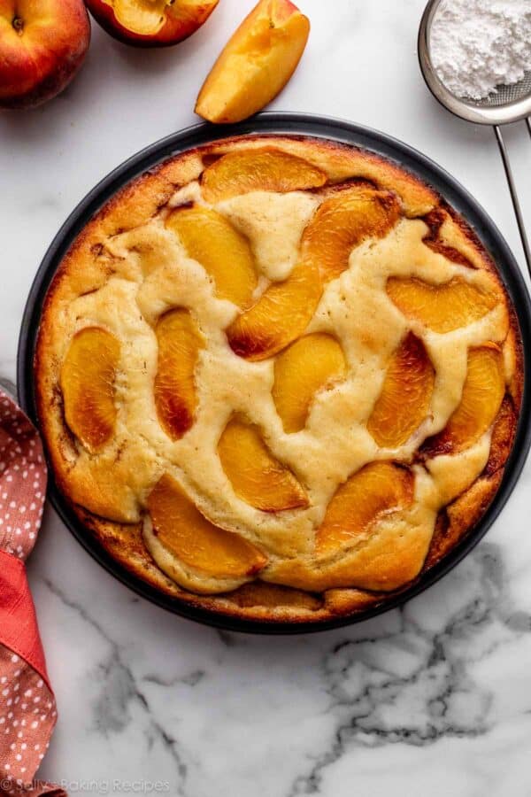 overhead view of fresh peach cake with peach slices baked in right on top.