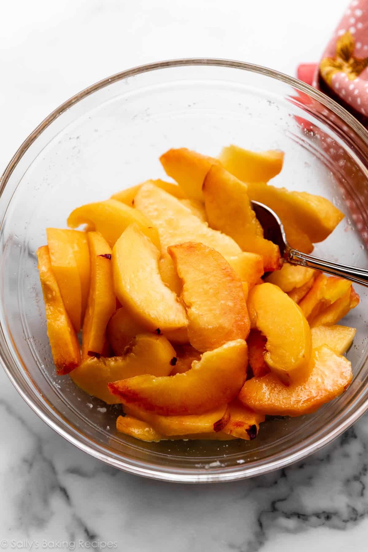 peach slices in glass bowl.