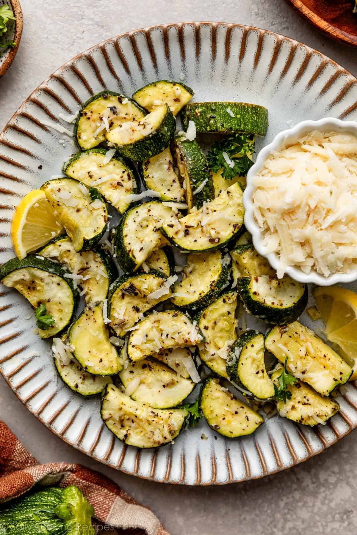 roasted lemon garlic zucchini pieces with parmesan on top.