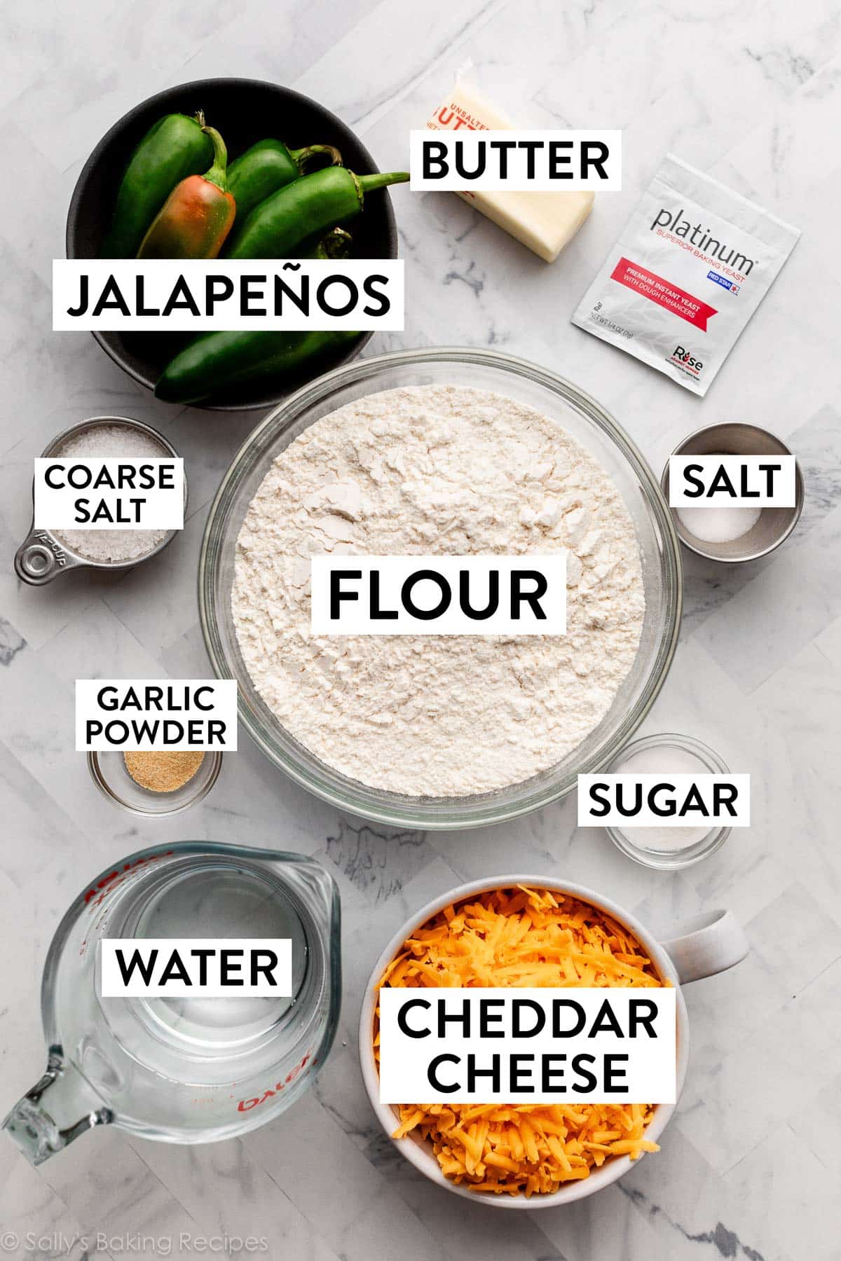 ingredients in bowls including jalapeños, flour, garlic powder, cheddar cheese, sugar, and salt.