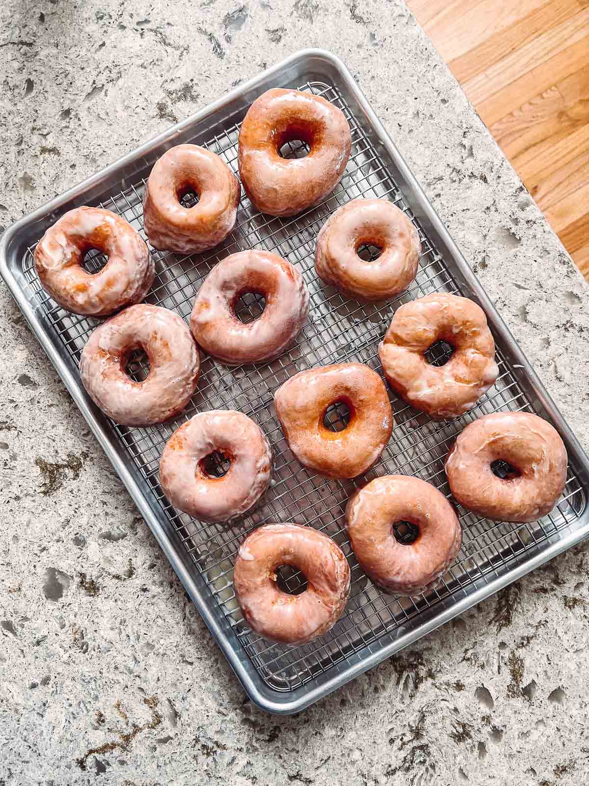 glazed doughnuts on baking sheet.