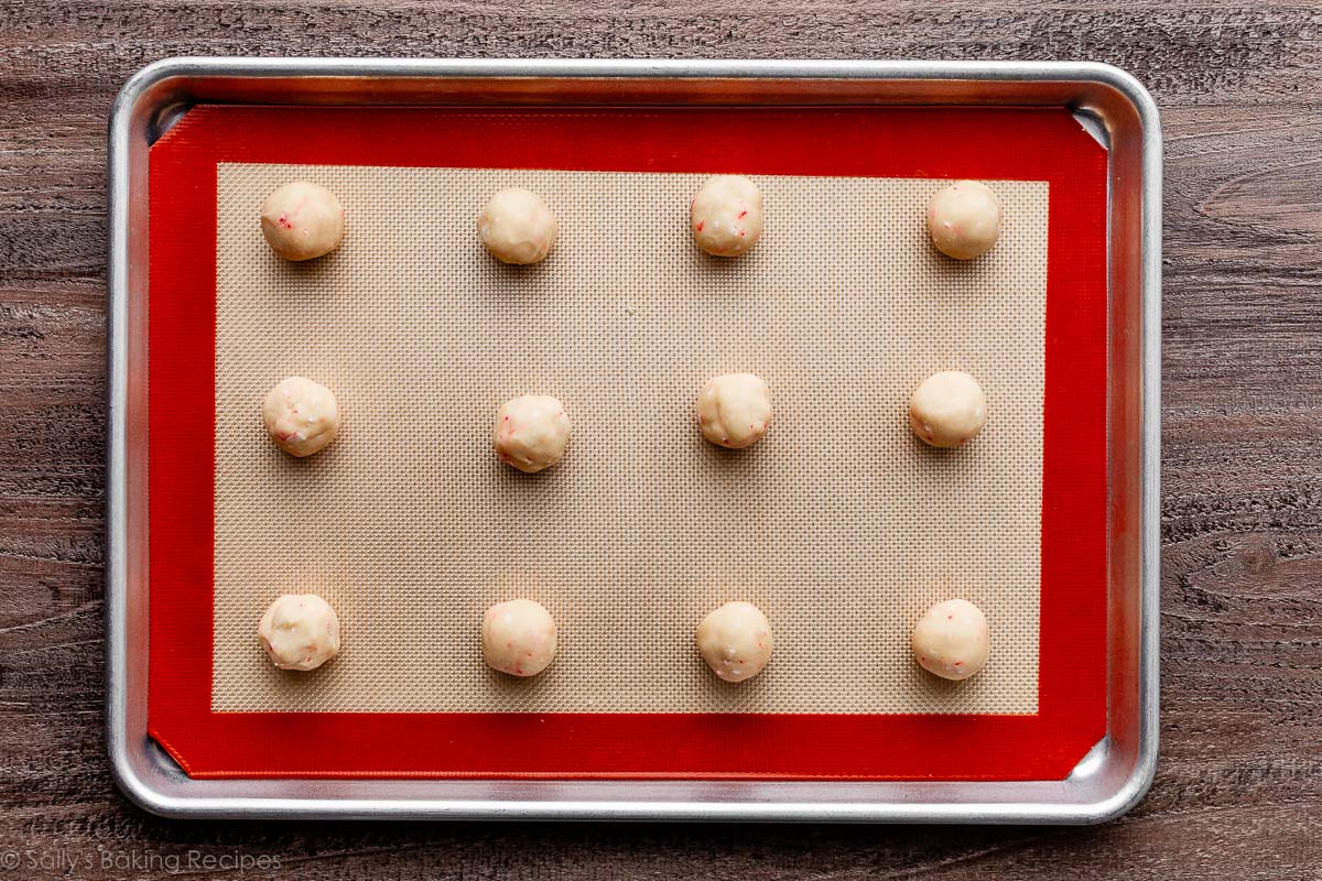 rolled peppermint cookies on lined baking sheet.