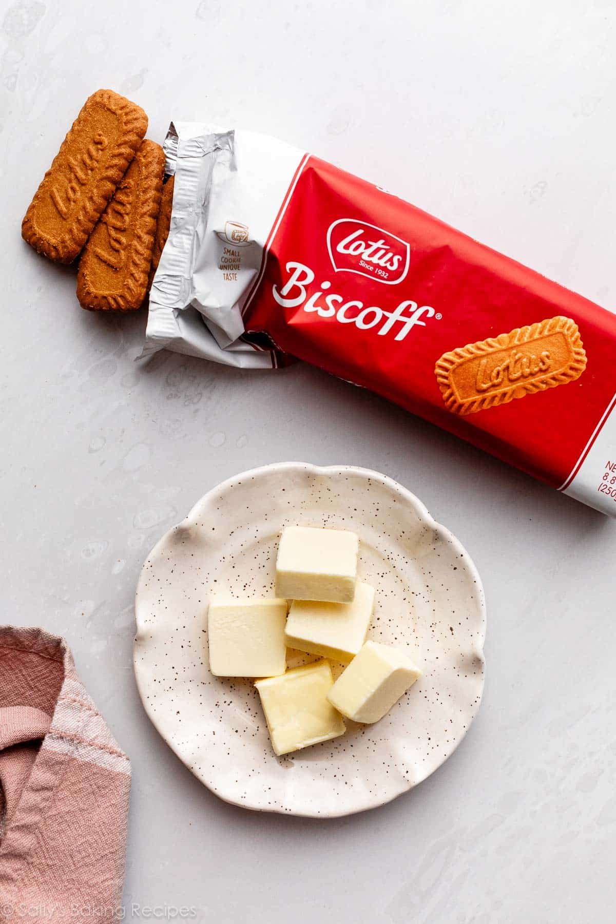 dish of slices of butter and a package of Lotus brand Biscoff cookies.