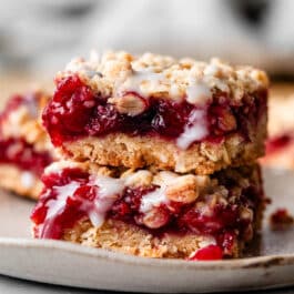 stack of 2 cherry pie bars with icing.