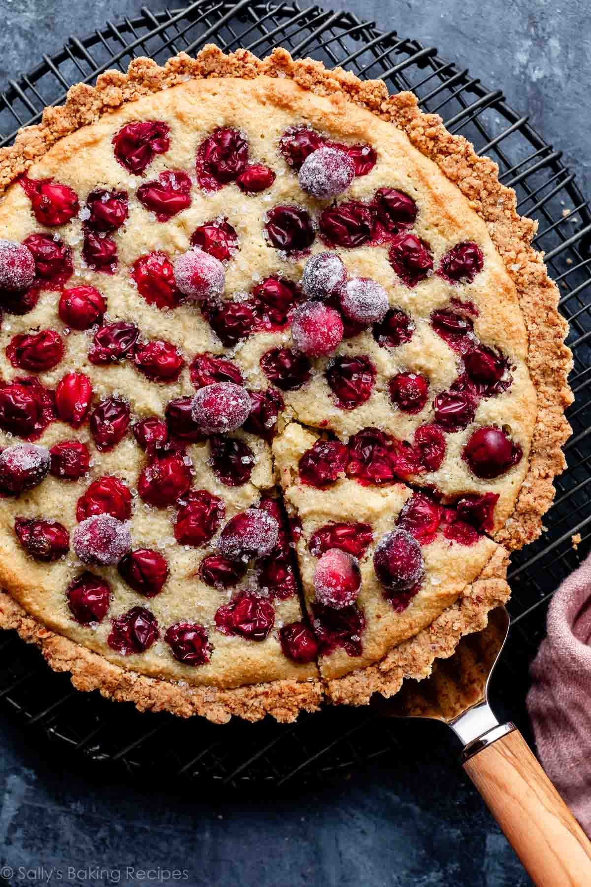 cranberry frangipane tart with sugared cranberries on top.