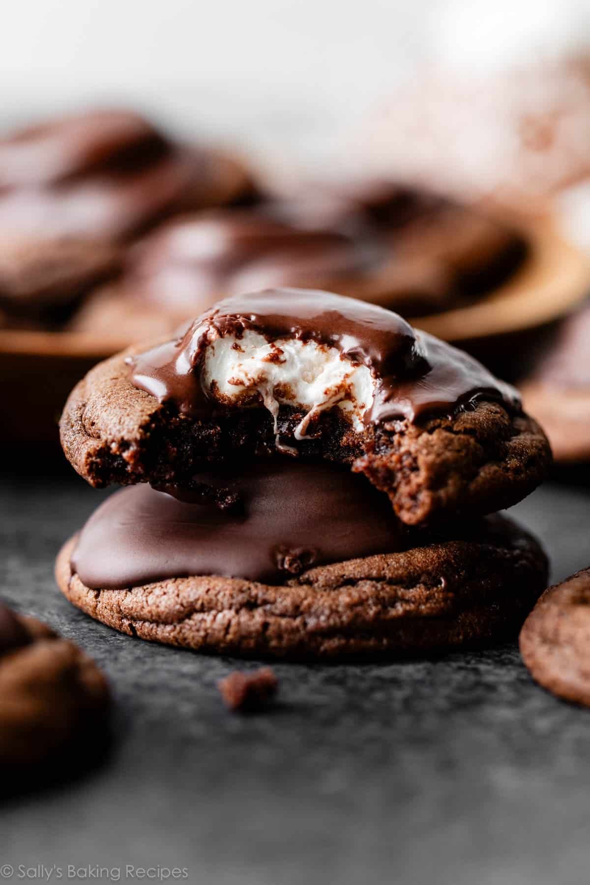 stack of two marshmallow-filled hot cocoa cookies with melted chocolate on top.