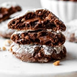stack of Nutella crinkle cookies with gooey Nutella in the center.