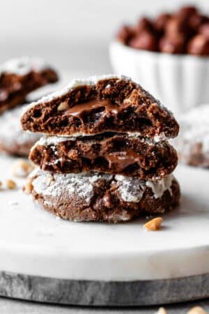 stack of Nutella crinkle cookies with gooey Nutella in the center.