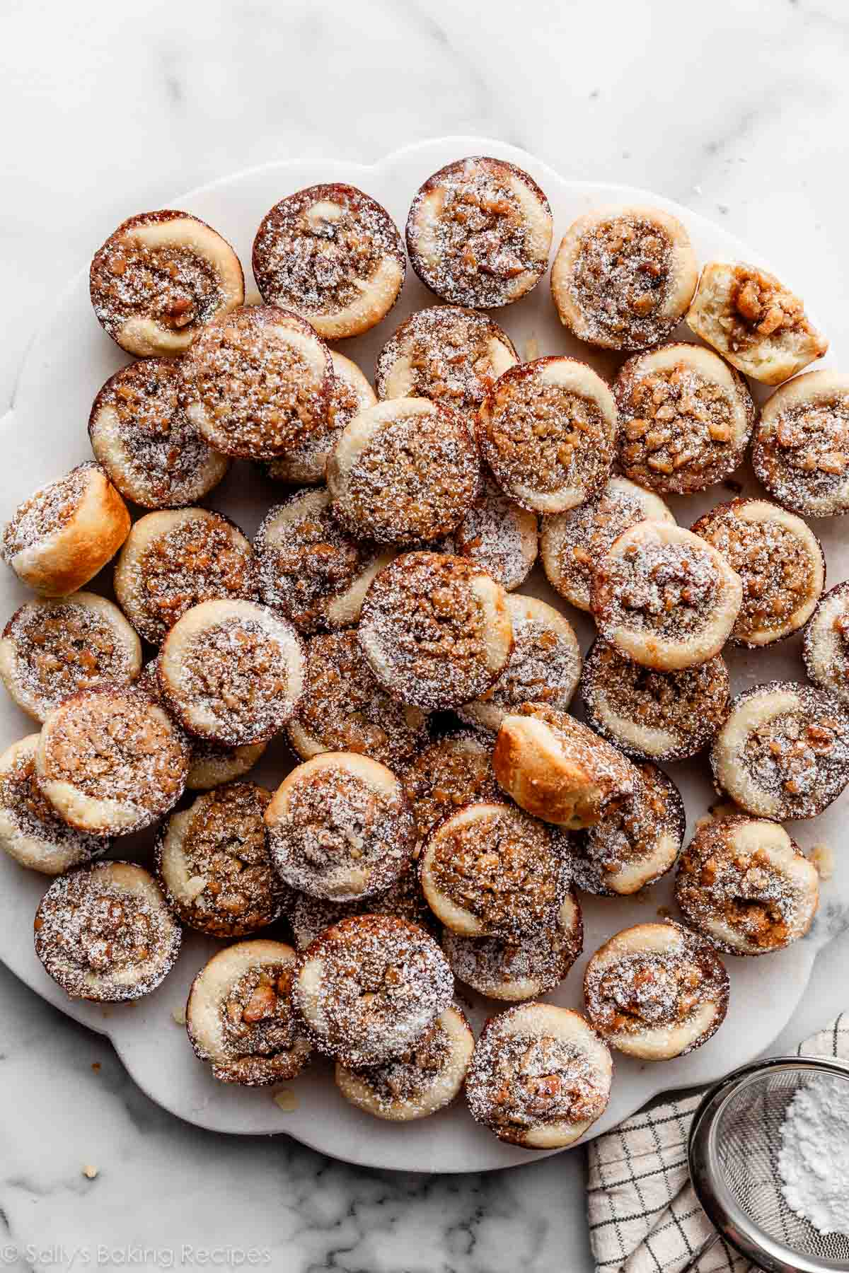 maple walnut tassies with sprinkle of confectioners' sugar on top.