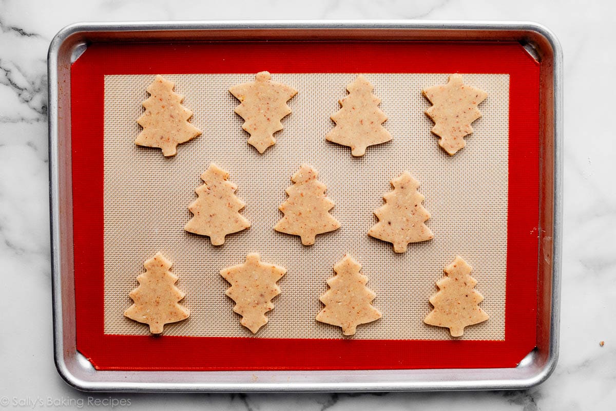tree-shaped cookie dough on lined baking sheet.