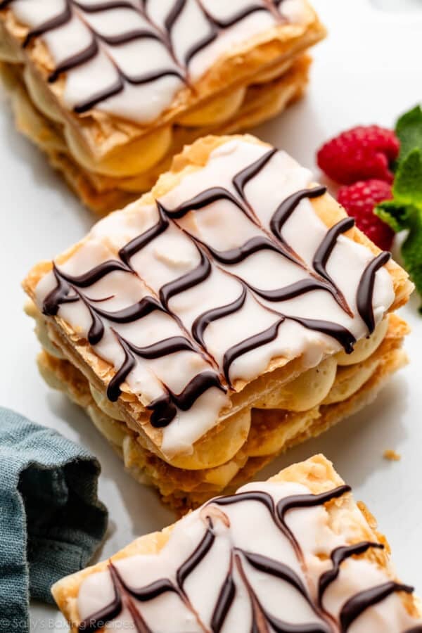 mille feuille napoleon pastry stack with vanilla icing and chevron-style swirled melted chocolate on top.
