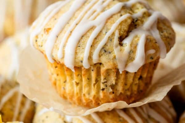 close-up of lemon poppy seed muffin with icing on top.