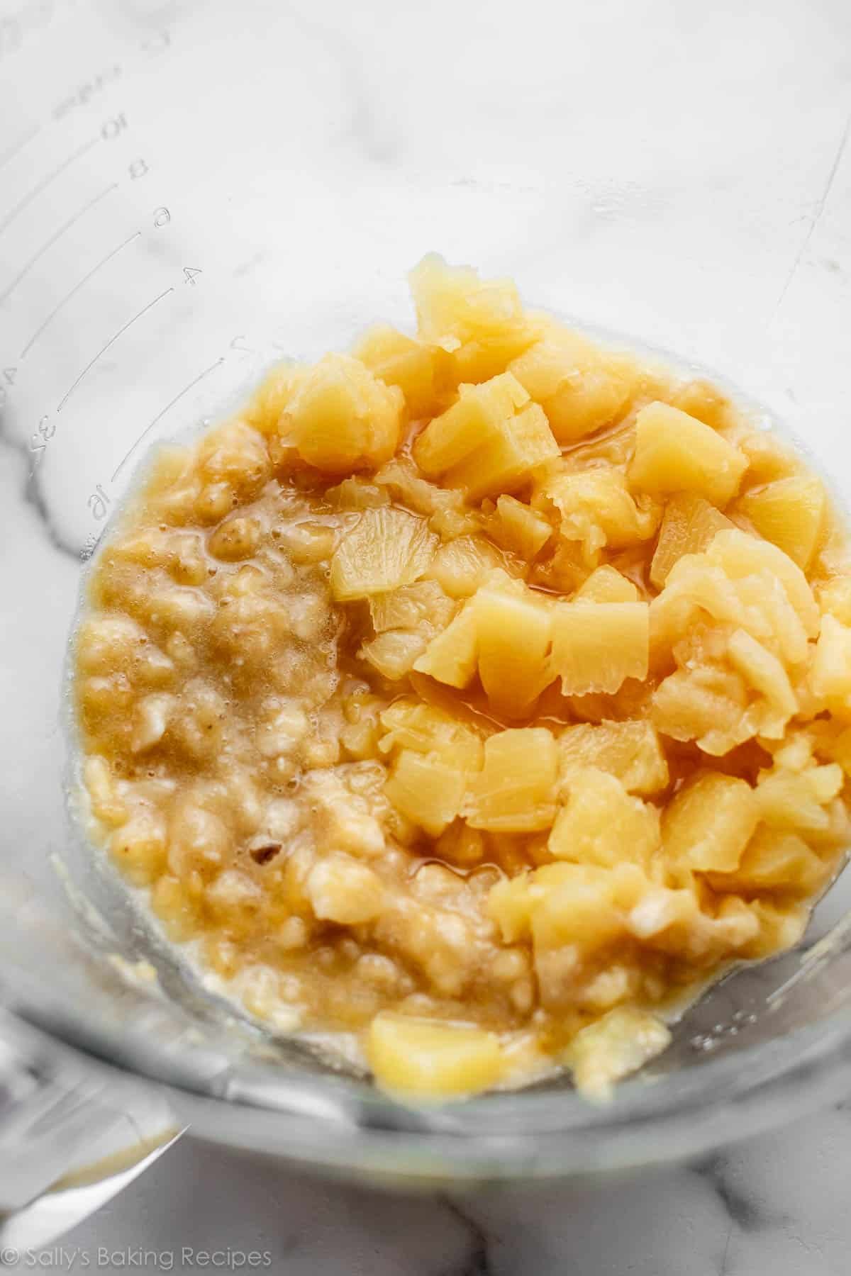 mashed banana and pineapple chunks in a glass bowl.