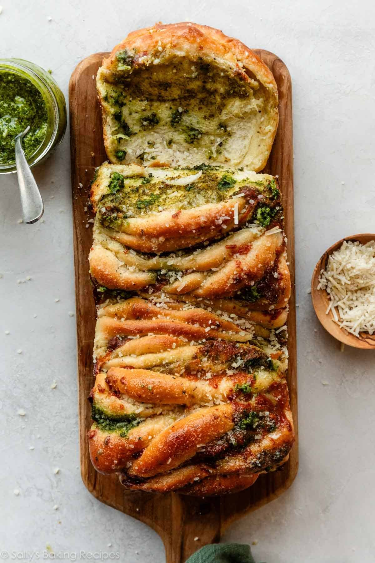 overhead photo of pesto pull-apart bread with parmesan cheese sprinkled on top.