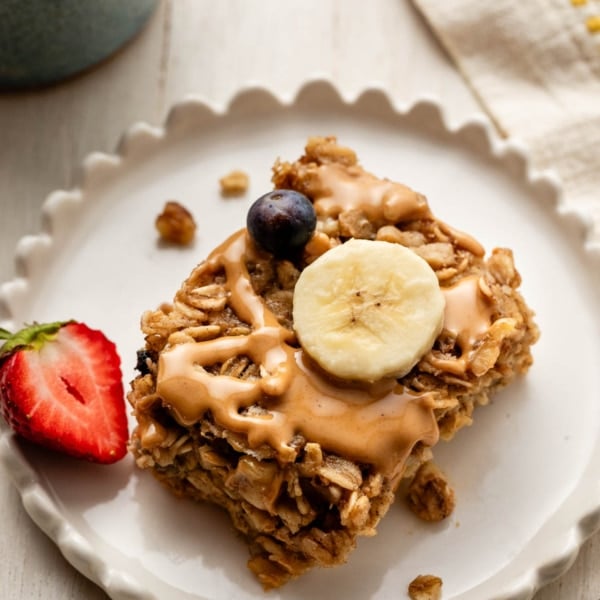 serving of banana baked oatmeal with melted peanut butter on top.