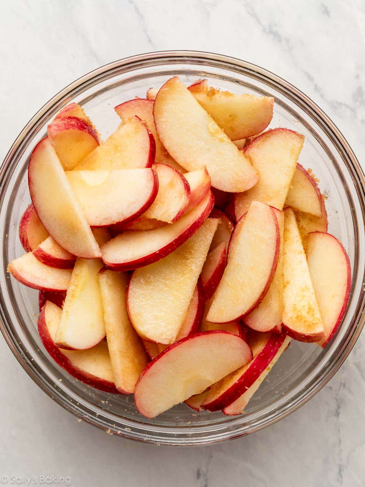 apple slices with brown sugar in bowl.