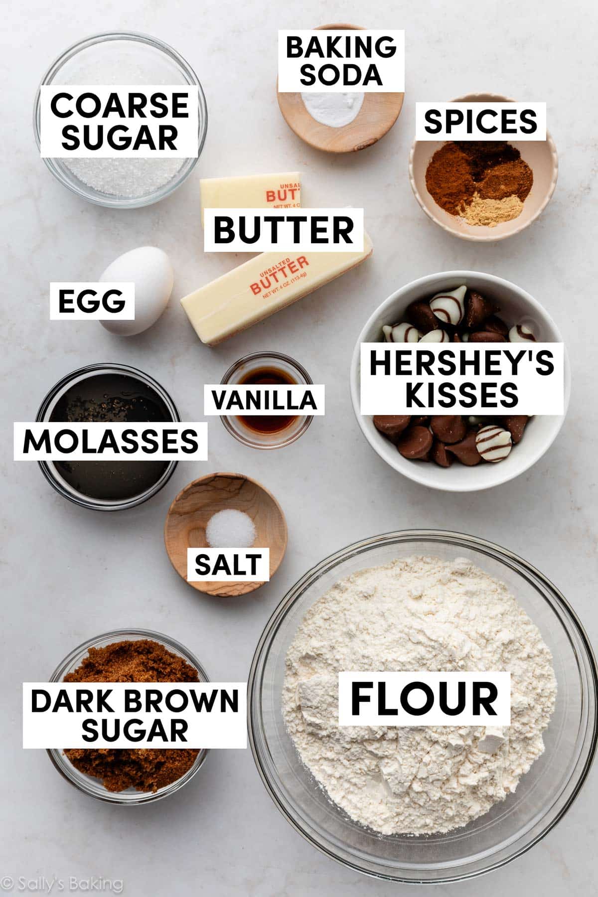 ingredients in bowls including spices, flour, dark brown sugar, molasses, and butter.