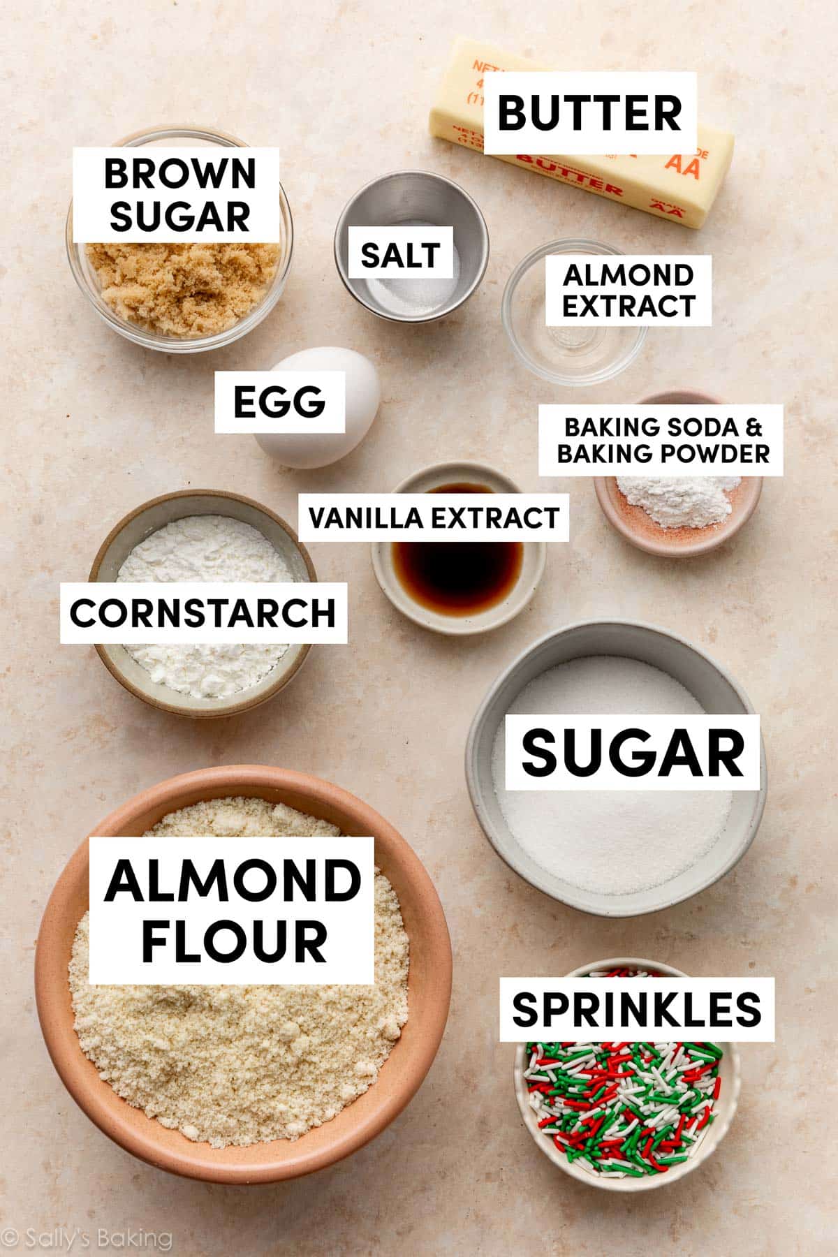 ingredients in bowls including butter, brown sugar, almond flour, sprinkles, cornstarch, and sugar.