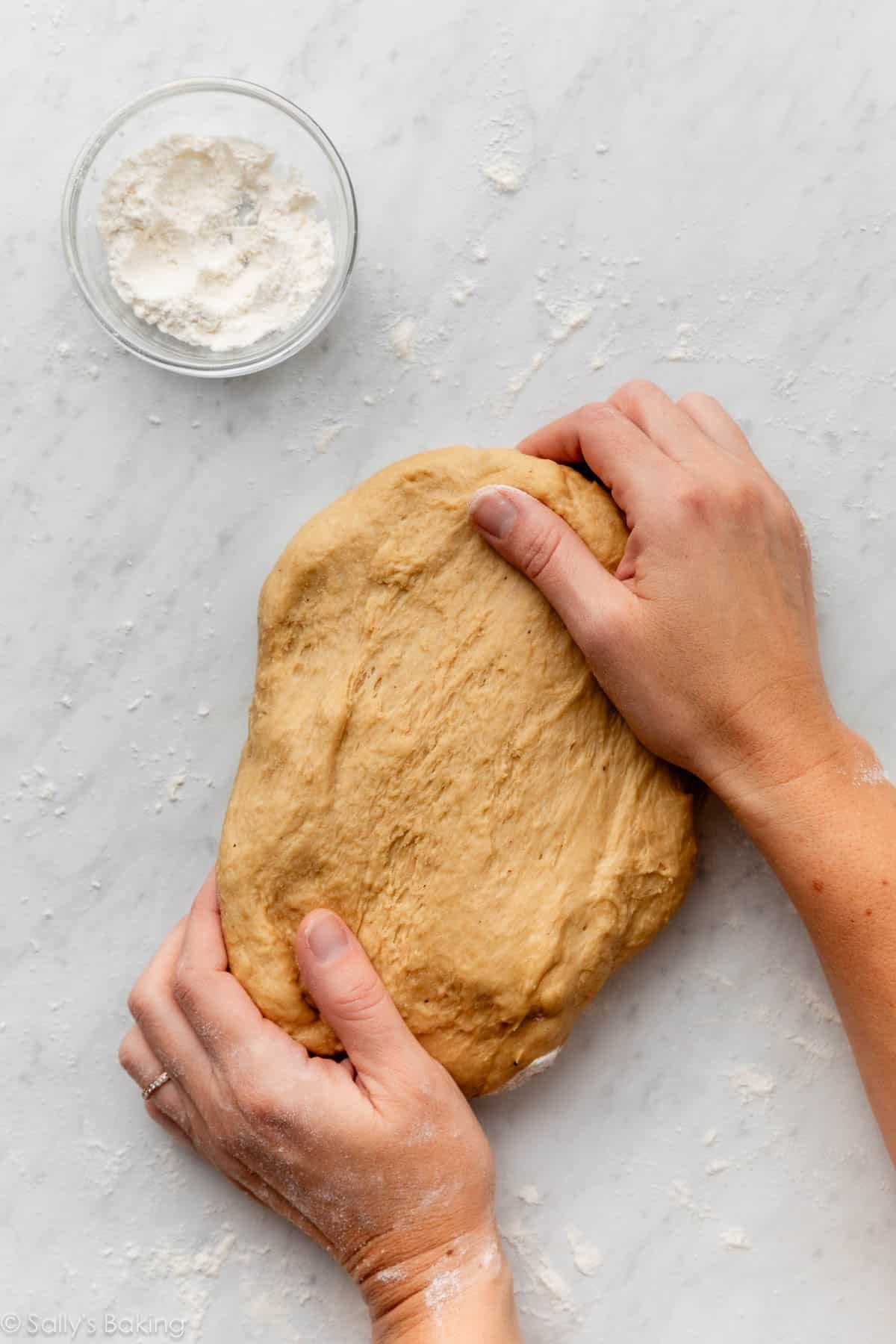 hands kneading dough.