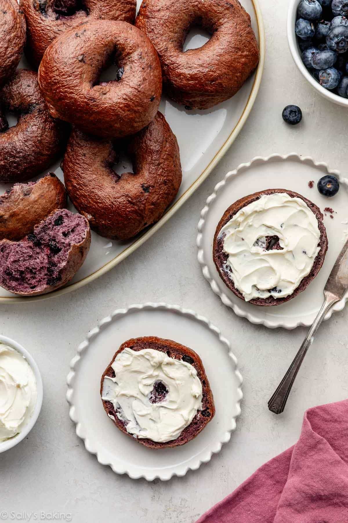 blueberry bagel with cream cheese on top.