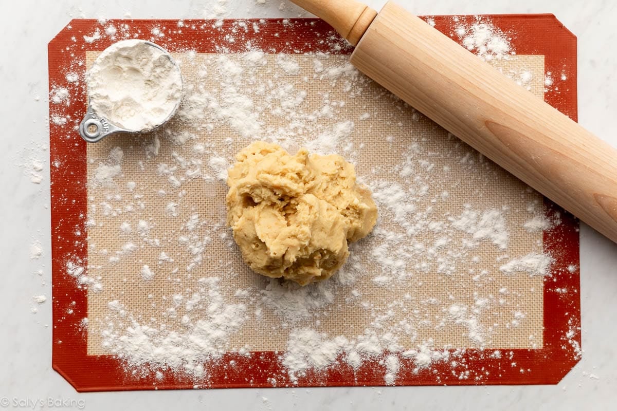 cookie dough on floured silicone baking mat.