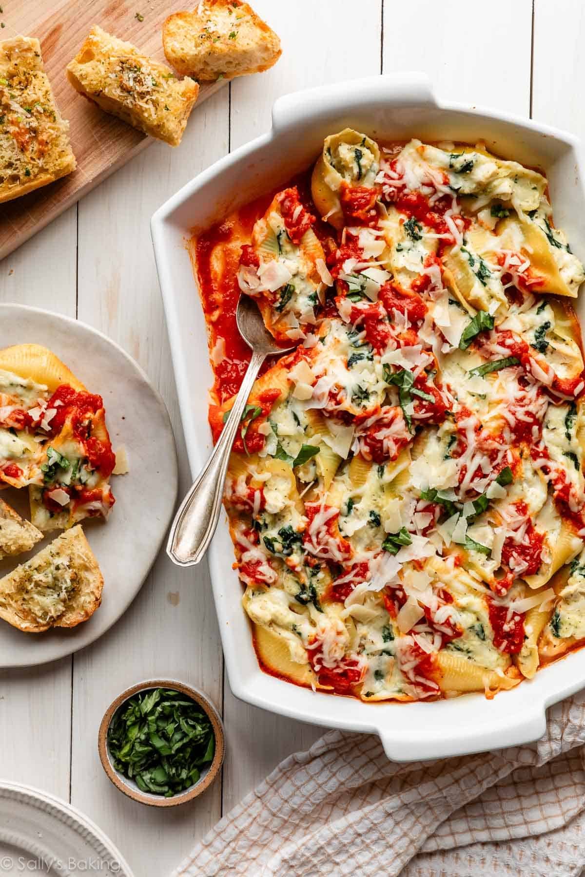 creamy chicken stuffed shells with marinara and garlic spinach.