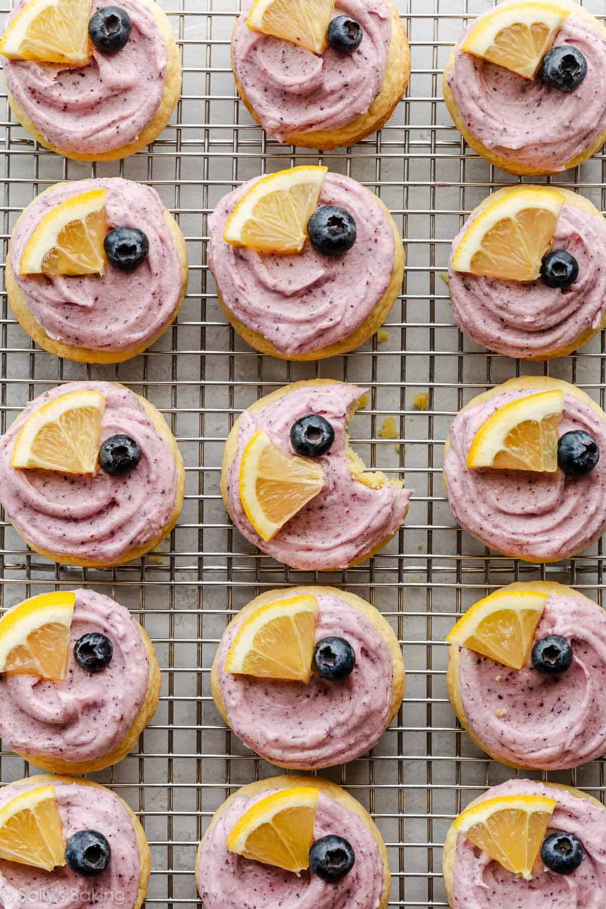 frosted lemon blueberry cookies on cooling rack.