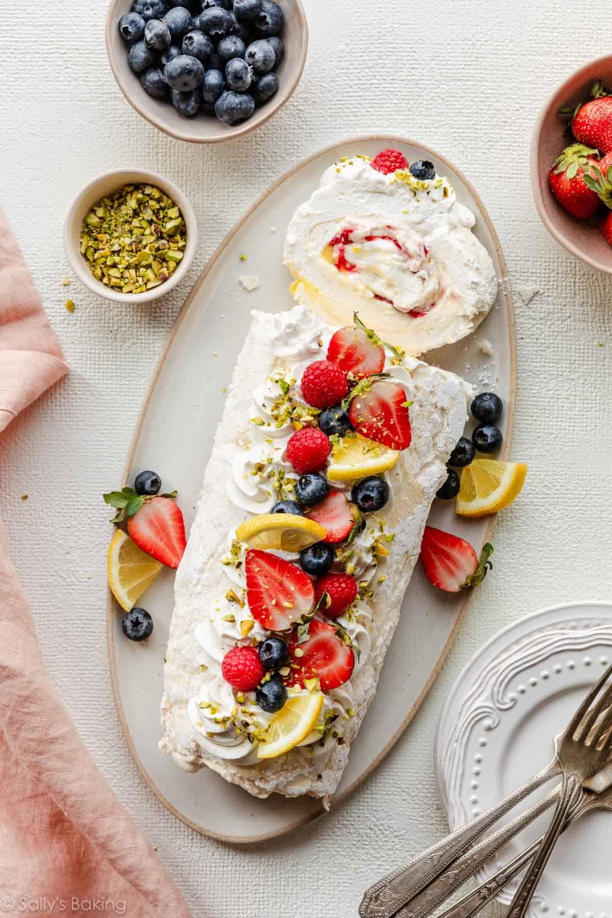 meringue roulade with fresh berries, lemon, and crushed pistachios.