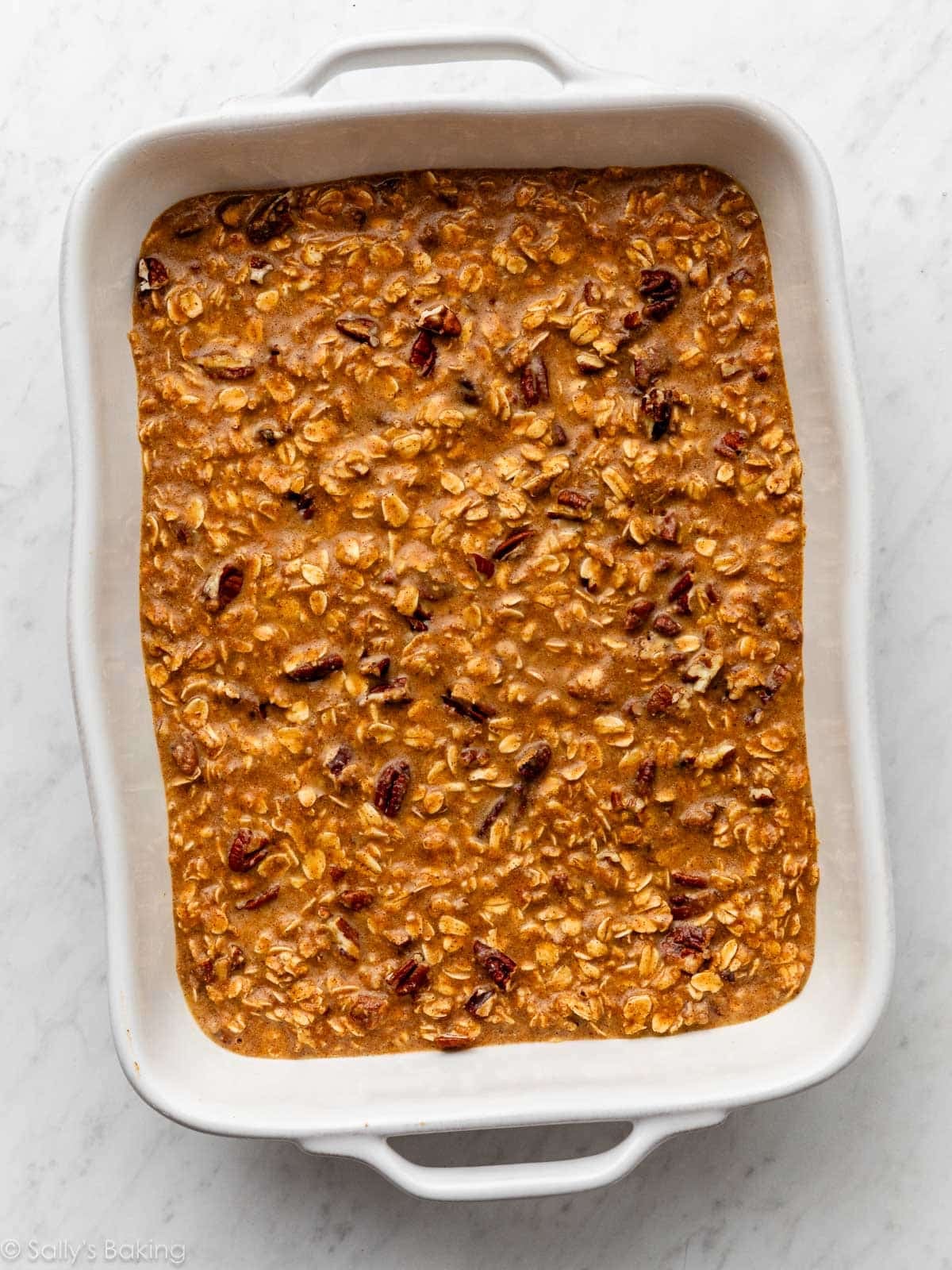 oatmeal mixture in a white ceramic baking dish.