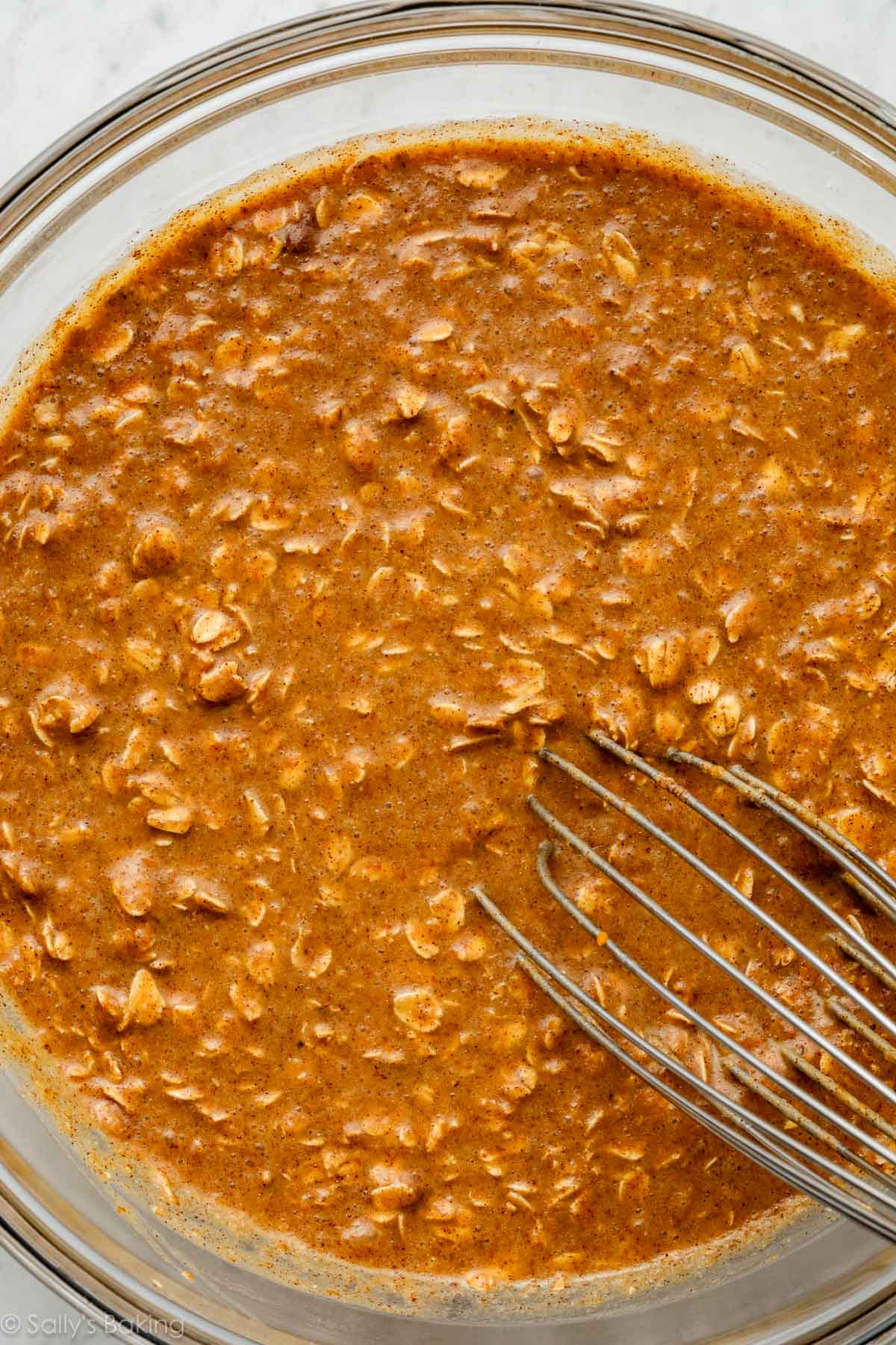 whisking oatmeal mixture in bowl.