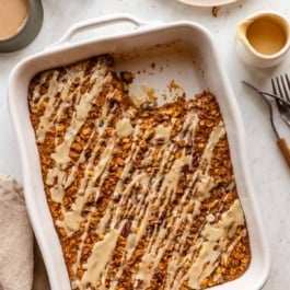 pumpkin baked oatmeal in a white ceramic baking dish.