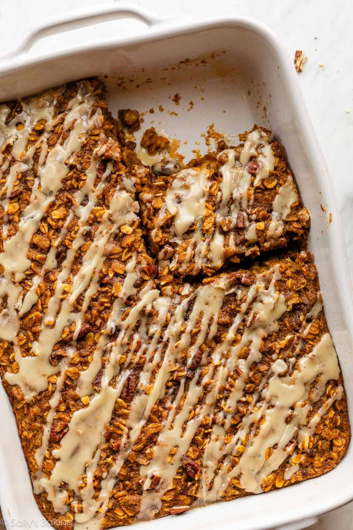 pumpkin baked oatmeal with maple glaze in a white ceramic dish.